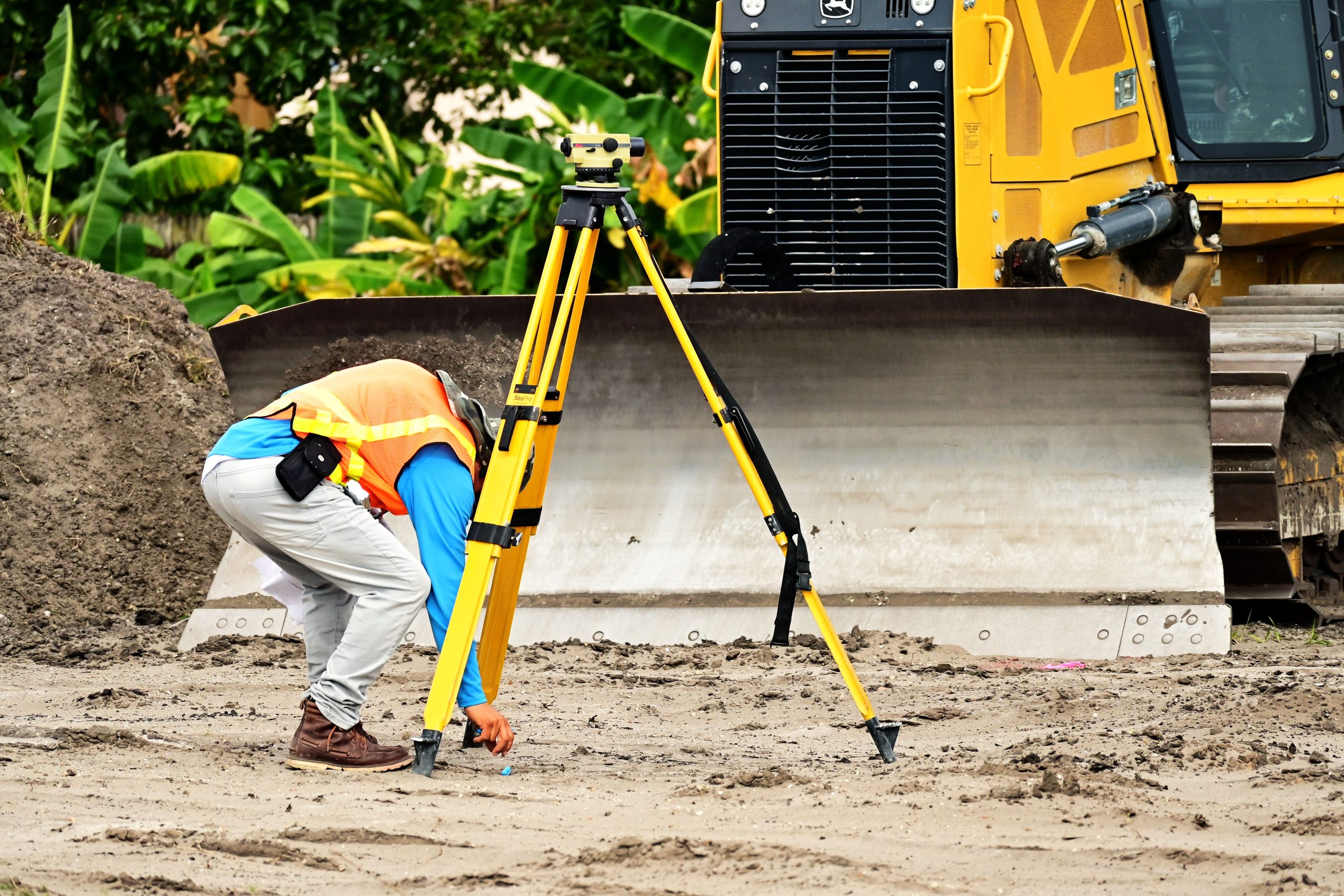 Ouvrier utilisant une station totale sur chantier